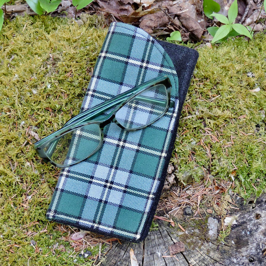 Cape Breton Tartan  glasses case with green glasses on a mossy surface