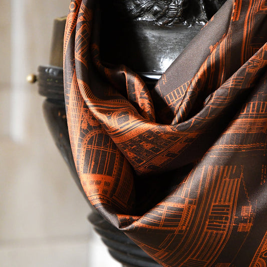 Brown and orange scarf featuring architectural illustrations of the NYPL's flagship building.