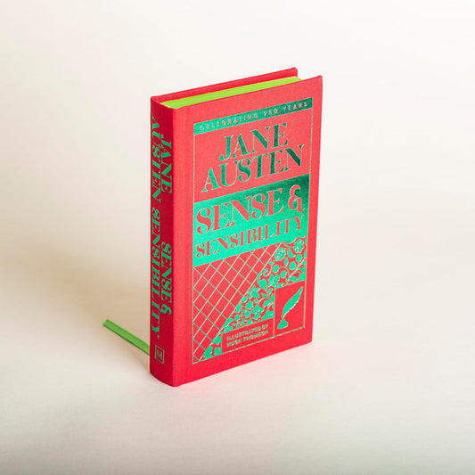 Red book titled 'Sense and Sensibility' by Jane Austen on a light background