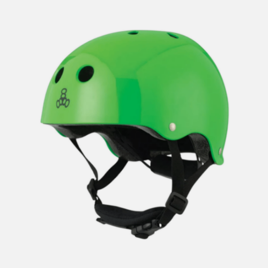 Green helmet with black straps on a light gray background